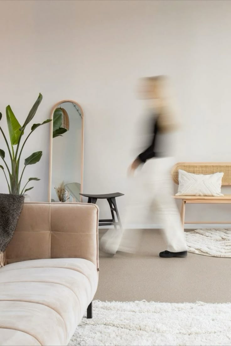 Blurred figure moving through a warm, neutral interior, motion blur